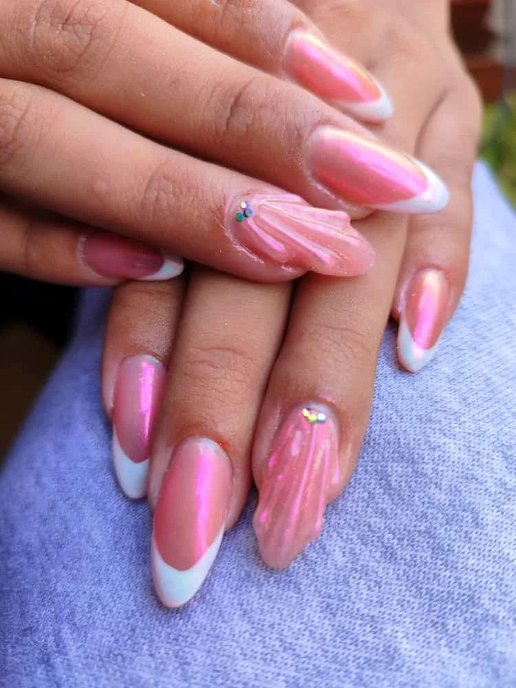 Uñas largas rosa con puntas blancas y detalles brillantes